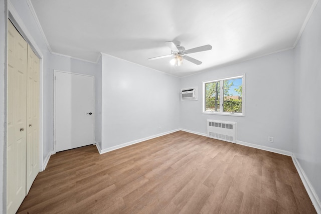 1549 E 57th St, Brooklyn, NY 11234 - unfurnished bedroom with radiator heating unit, an AC wall unit, wood finished floors, baseboards, and crown molding