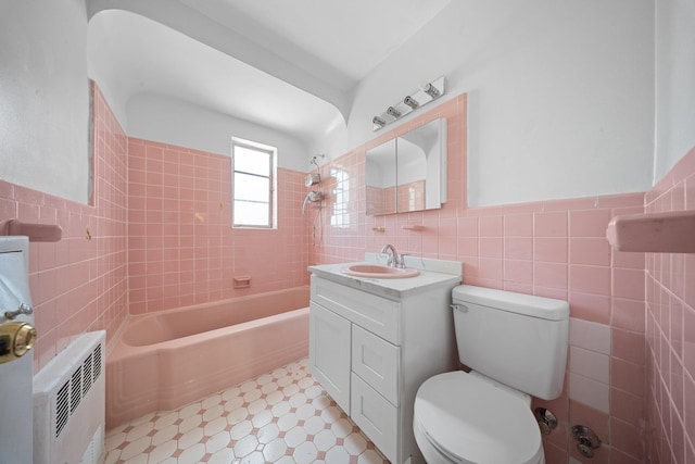 1549 E 57th St, Brooklyn, NY 11234 - full bath featuring tile walls, toilet, vanity, washtub / shower combination, and wainscoting