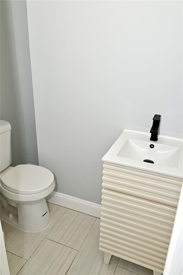 200-13 116th Ave, Saint Albans, NY 11412 - bathroom with toilet, vanity, baseboards, and wood tiled floors