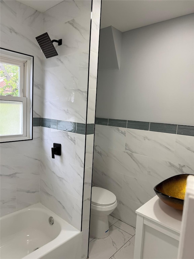 200-13 116th Ave, Saint Albans, NY 11412 - bathroom featuring toilet, tile walls, marble look tile flooring, vanity, and tub / shower combination