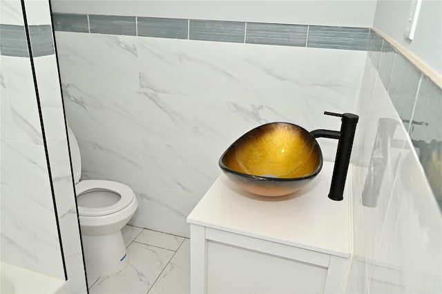 200-13 116th Ave, Saint Albans, NY 11412 - bathroom featuring marble finish floors, toilet, tile walls, and vanity