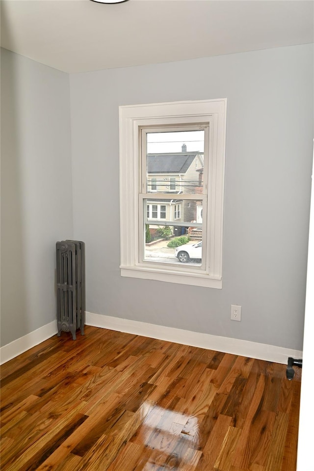 200-13 116th Ave, Saint Albans, NY 11412 - spare room with radiator, wood finished floors, and baseboards