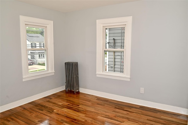 200-13 116th Ave, Saint Albans, NY 11412 - unfurnished room featuring radiator heating unit, wood finished floors, and baseboards