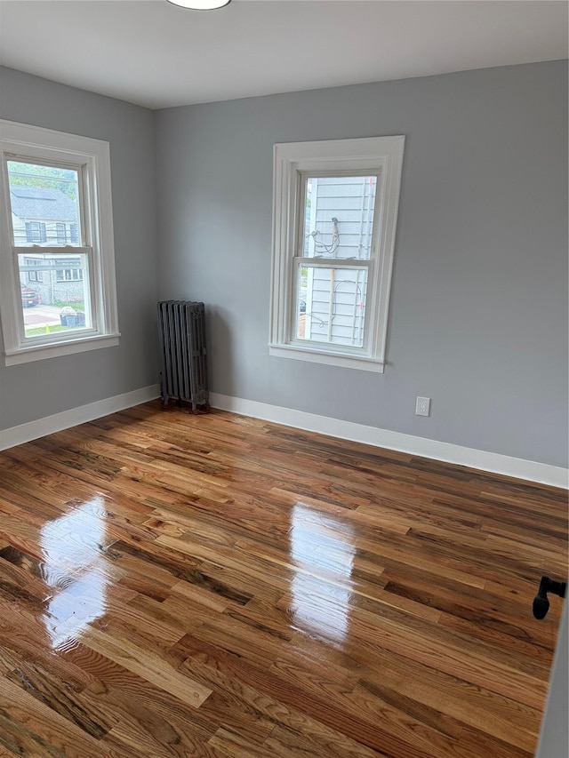 200-13 116th Ave, Saint Albans, NY 11412 - empty room with radiator, dark wood-type flooring, and baseboards
