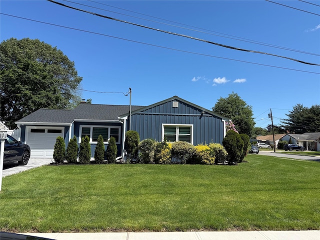 1510 Rica Pl, Valley Stream, NY 11580 - view of front of property featuring board and batten siding, a garage, a front yard, and driveway
