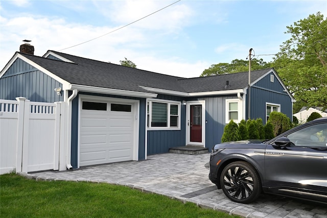 1510 Rica Pl, Valley Stream, NY 11580 - view of front facade with a chimney, a garage, roof with shingles, and board and batten siding