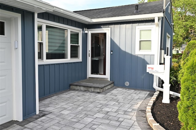 1510 Rica Pl, Valley Stream, NY 11580 - doorway to property featuring board and batten siding, roof with shingles, and a patio