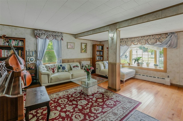 20 Baylis Pl, Syosset, NY 11791 - living room with a baseboard radiator, hardwood / wood-style floors, wallpapered walls, crown molding, and a wainscoted wall
