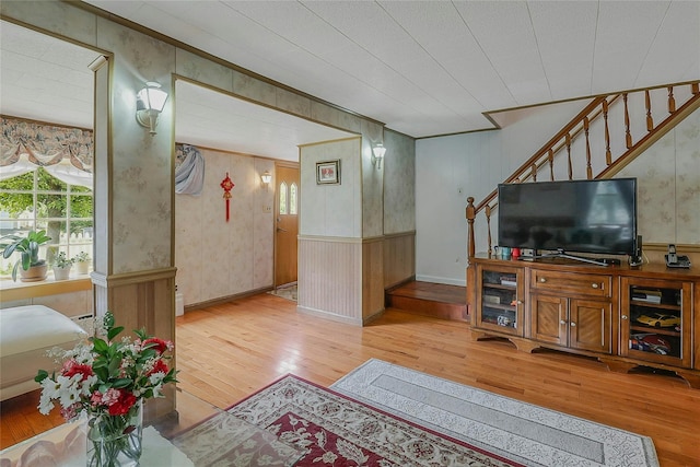 20 Baylis Pl, Syosset, NY 11791 - living room with light wood finished floors, stairway, a wainscoted wall, and wooden walls