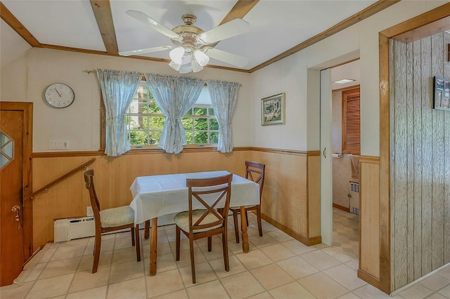 20 Baylis Pl, Syosset, NY 11791 - dining space featuring a wainscoted wall, ceiling fan, radiator, light tile patterned floors, and wooden walls
