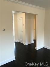 49 Tanager Rd Unit 4905, Monroe, NY 10950 - spare room featuring crown molding, baseboards, and dark wood-style floors