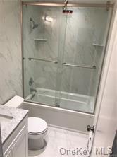 49 Tanager Rd Unit 4905, Monroe, NY 10950 - bathroom featuring toilet, vanity, and shower / bath combination with glass door
