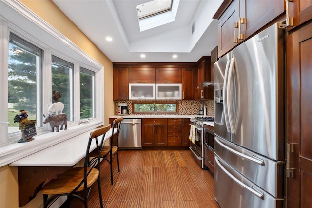 3 Knight Ln, Kings Park, NY 11754 - kitchen with appliances with stainless steel finishes, a skylight, backsplash, light countertops, and wood finished floors