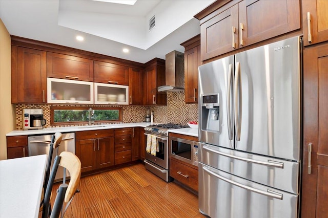 3 Knight Ln, Kings Park, NY 11754 - kitchen with stainless steel appliances, wall chimney range hood, a sink, light countertops, and backsplash