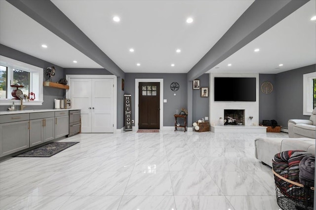 3 Knight Ln, Kings Park, NY 11754 - living area featuring recessed lighting, baseboards, a fireplace with raised hearth, light marble finish floors, and baseboard heating