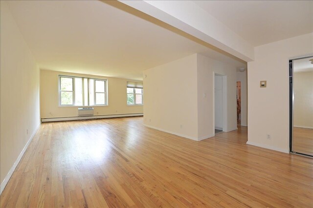 25 Canterbury Rd Unit 3-T, Great Neck, NY 11021 - unfurnished room featuring baseboard heating, light wood finished floors, and baseboards