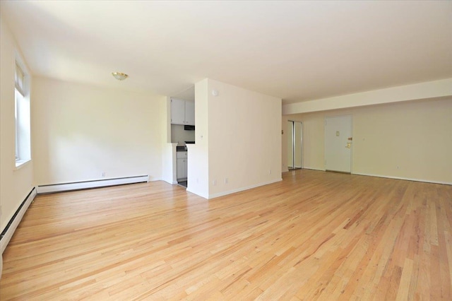 25 Canterbury Rd Unit 3-T, Great Neck, NY 11021 - unfurnished room featuring light wood-style flooring, baseboard heating, and baseboards