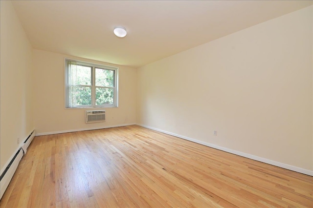 25 Canterbury Rd Unit 3-T, Great Neck, NY 11021 - spare room with a wall mounted AC, light wood-style flooring, baseboard heating, and baseboards