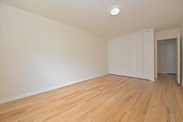 25 Canterbury Rd Unit 3-T, Great Neck, NY 11021 - unfurnished bedroom featuring wood finished floors, a closet, and baseboards