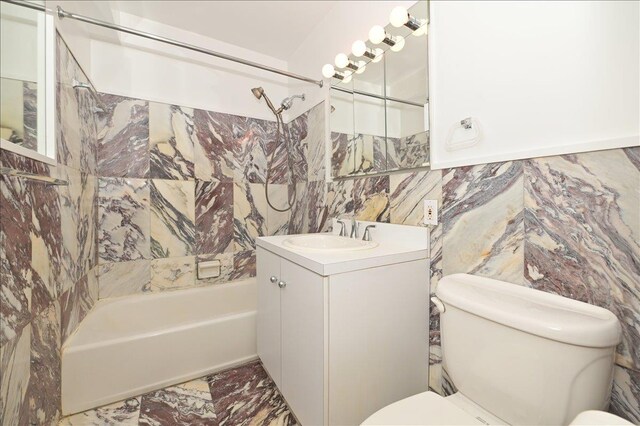 25 Canterbury Rd Unit 3-T, Great Neck, NY 11021 - bathroom with toilet, shower / bathtub combination, vanity, tile walls, and marble finish flooring