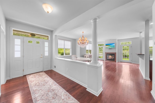 1 Country Club Dr, Middletown, NY 10940 - foyer entrance featuring dark wood-type flooring, decorative columns, a glass covered fireplace, a chandelier, and baseboards