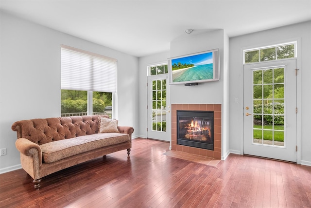 1 Country Club Dr, Middletown, NY 10940 - living room with wood-type flooring, a tiled fireplace, plenty of natural light, and baseboards