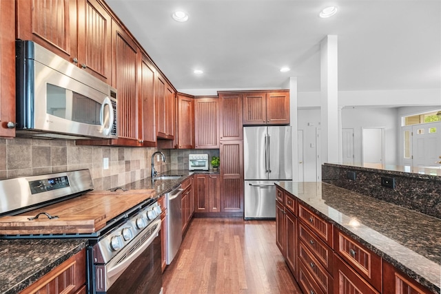 1 Country Club Dr, Middletown, NY 10940 - kitchen with stainless steel appliances, a sink, dark wood-type flooring, dark stone counters, and recessed lighting