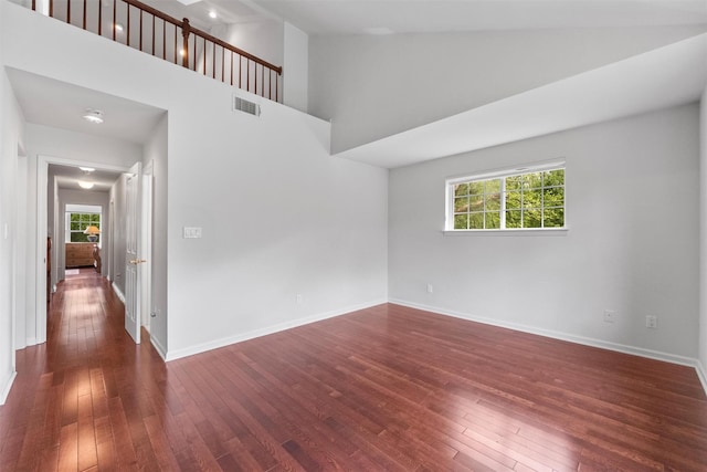 1 Country Club Dr, Middletown, NY 10940 - empty room with dark wood-type flooring, a high ceiling, and baseboards