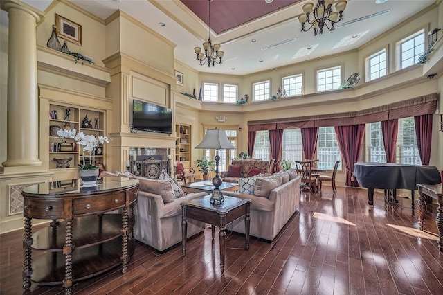 1 Country Club Dr, Middletown, NY 10940 - living room featuring a chandelier, decorative columns, a high ceiling, dark wood-type flooring, and crown molding