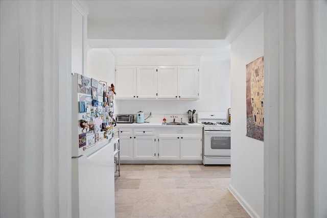 210 Pelham Rd Unit 6F, New Rochelle, NY 10805 - kitchen featuring white appliances, white cabinets, light countertops, and a sink