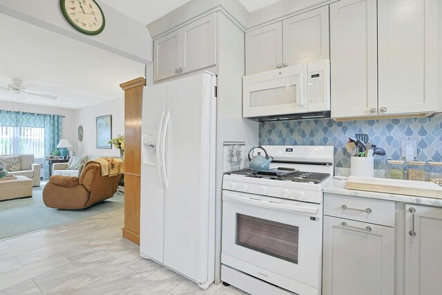 135-5 S Highland Ave Unit D4, Ossining, NY 10562 - kitchen with white appliances, open floor plan, backsplash, ceiling fan, and light countertops