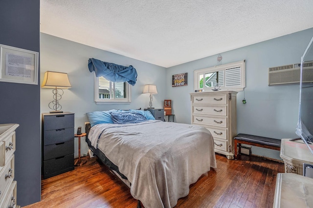379 Columbus Ave, West Babylon, NY 11704 - bedroom with dark wood-style floors, a wall mounted air conditioner, and a textured ceiling
