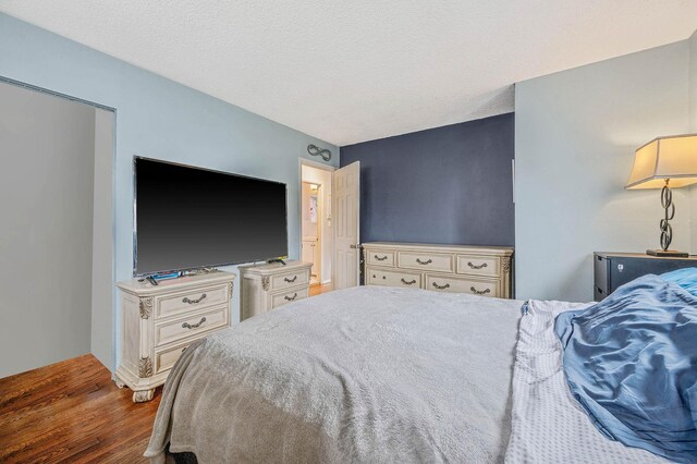 379 Columbus Ave, West Babylon, NY 11704 - bedroom with wood finished floors and a textured ceiling