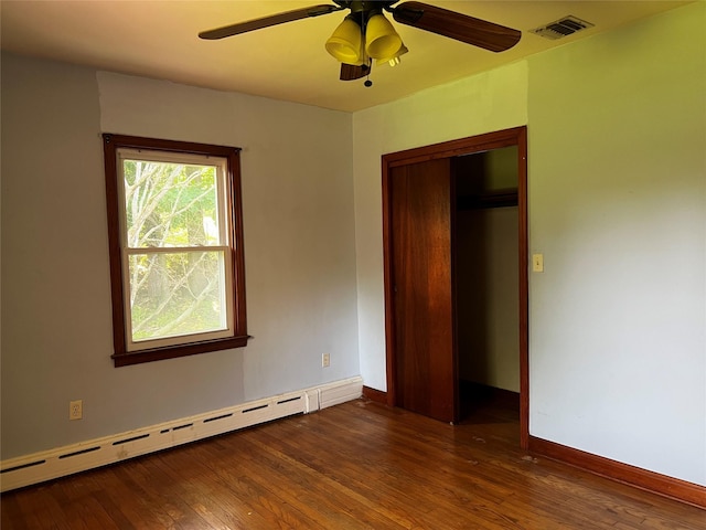 1 Hillside Ave, Haverstraw, NY 10927 - unfurnished bedroom with a baseboard heating unit, hardwood / wood-style flooring, a ceiling fan, and a closet