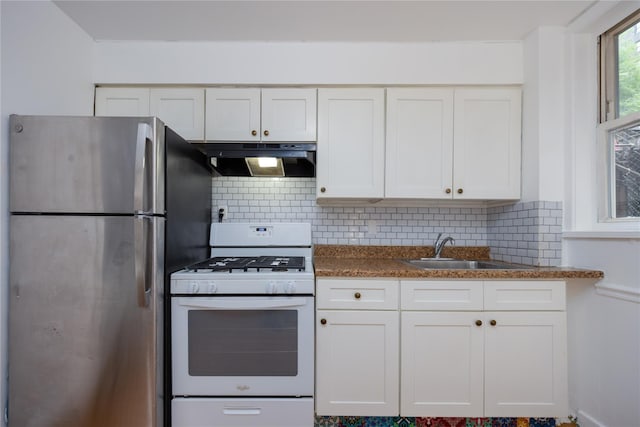 3496 Fort Independence St, Bronx, NY 10463 - kitchen with white gas stove, exhaust hood, freestanding refrigerator, a sink, and white cabinetry