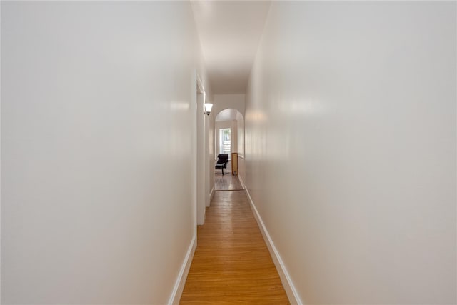 3496 Fort Independence St, Bronx, NY 10463 - hallway featuring arched walkways, baseboards, and light wood finished floors