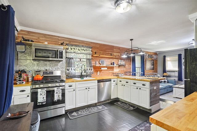 6 Gardner Hollow Rd, Poughquag, NY 12570 - kitchen with butcher block counters, stainless steel appliances, a peninsula, white cabinets, and wooden walls