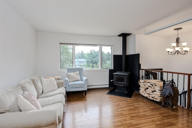 112 Middle Island Blvd, Middle Island, NY 11953 - living room with baseboard heating, a chandelier, wood finished floors, and a wood stove
