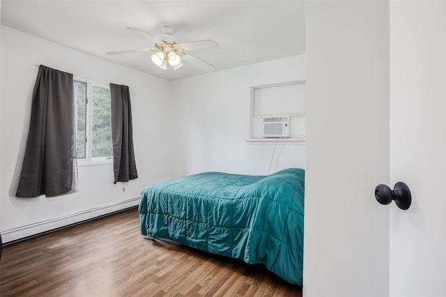 112 Middle Island Blvd, Middle Island, NY 11953 - bedroom with a baseboard radiator, wood finished floors, cooling unit, and a ceiling fan