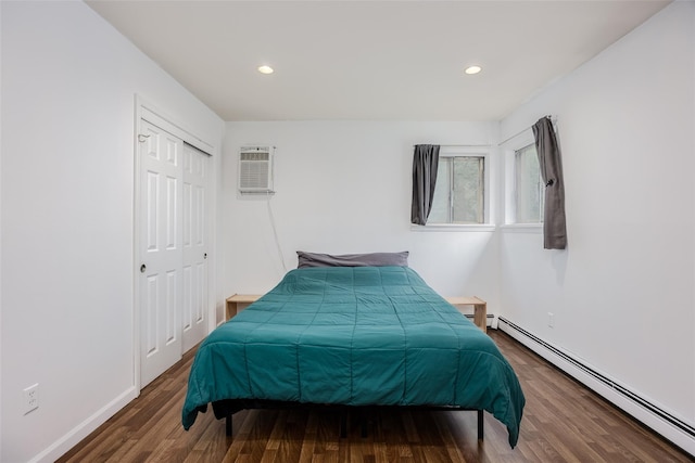 112 Middle Island Blvd, Middle Island, NY 11953 - bedroom with a baseboard heating unit, wood finished floors, recessed lighting, and a closet