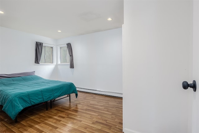 112 Middle Island Blvd, Middle Island, NY 11953 - bedroom featuring a baseboard radiator, wood finished floors, and recessed lighting