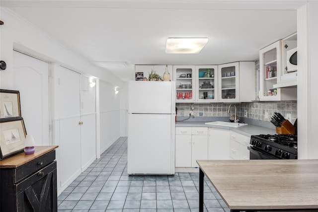 112 Middle Island Blvd, Middle Island, NY 11953 - kitchen featuring freestanding refrigerator, black gas range, light countertops, light tile patterned flooring, and under cabinet range hood