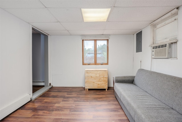 112 Middle Island Blvd, Middle Island, NY 11953 - living area with a baseboard radiator, wood finished floors, a baseboard heating unit, a drop ceiling, and electric panel