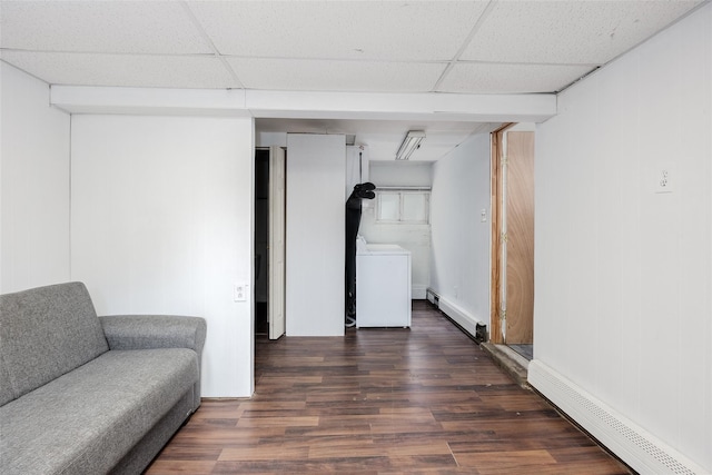 112 Middle Island Blvd, Middle Island, NY 11953 - finished below grade area featuring a baseboard heating unit, washer / clothes dryer, a baseboard radiator, a paneled ceiling, and wood finished floors