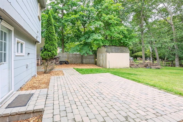 112 Middle Island Blvd, Middle Island, NY 11953 - fenced backyard featuring a patio, a storage unit, and view of wooded area