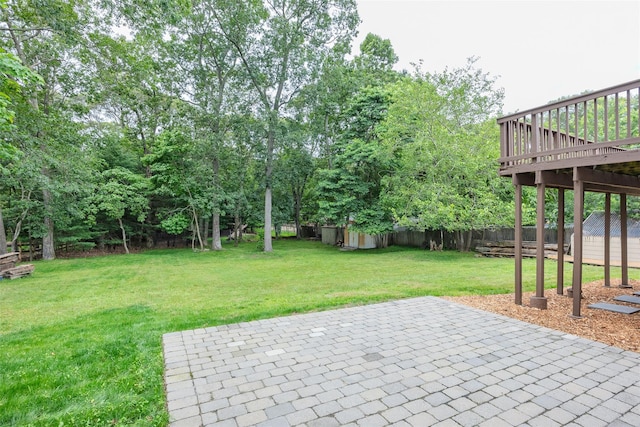 112 Middle Island Blvd, Middle Island, NY 11953 - fenced backyard featuring a storage unit, a patio area, and a wooden deck