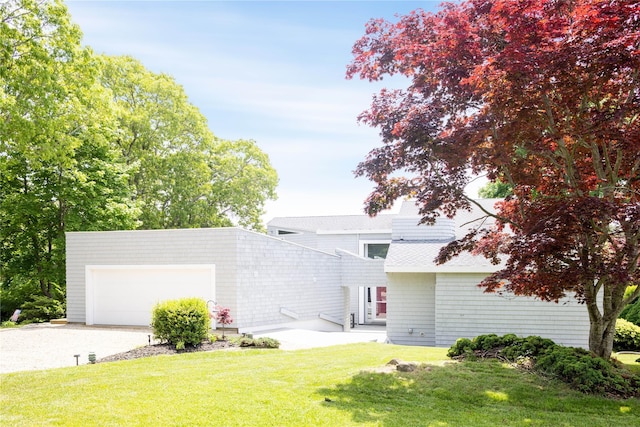 6 Bay View Dr, Hampton Bays, NY 11946 - view of front of house featuring concrete driveway, a front yard, a garage, and roof with shingles