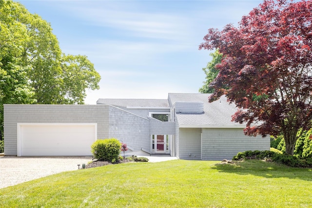 6 Bay View Dr, Hampton Bays, NY 11946 - view of front of house featuring driveway, a front lawn, and a garage