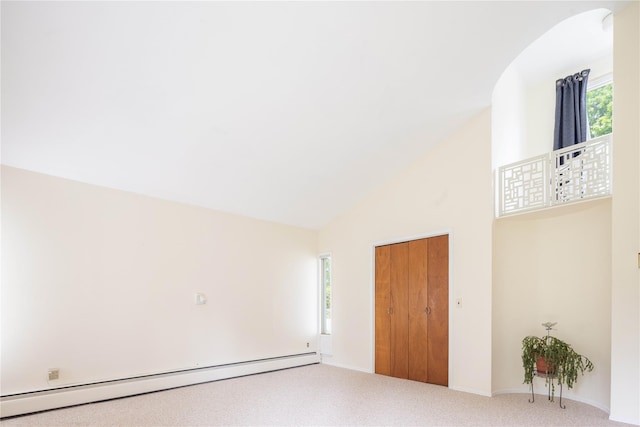 6 Bay View Dr, Hampton Bays, NY 11946 - carpeted empty room featuring baseboard heating, high vaulted ceiling, and baseboards