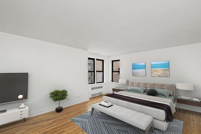 15 Oliver St Unit 3C, Brooklyn, NY 11209 - bedroom featuring radiator, wood finished floors, and baseboards